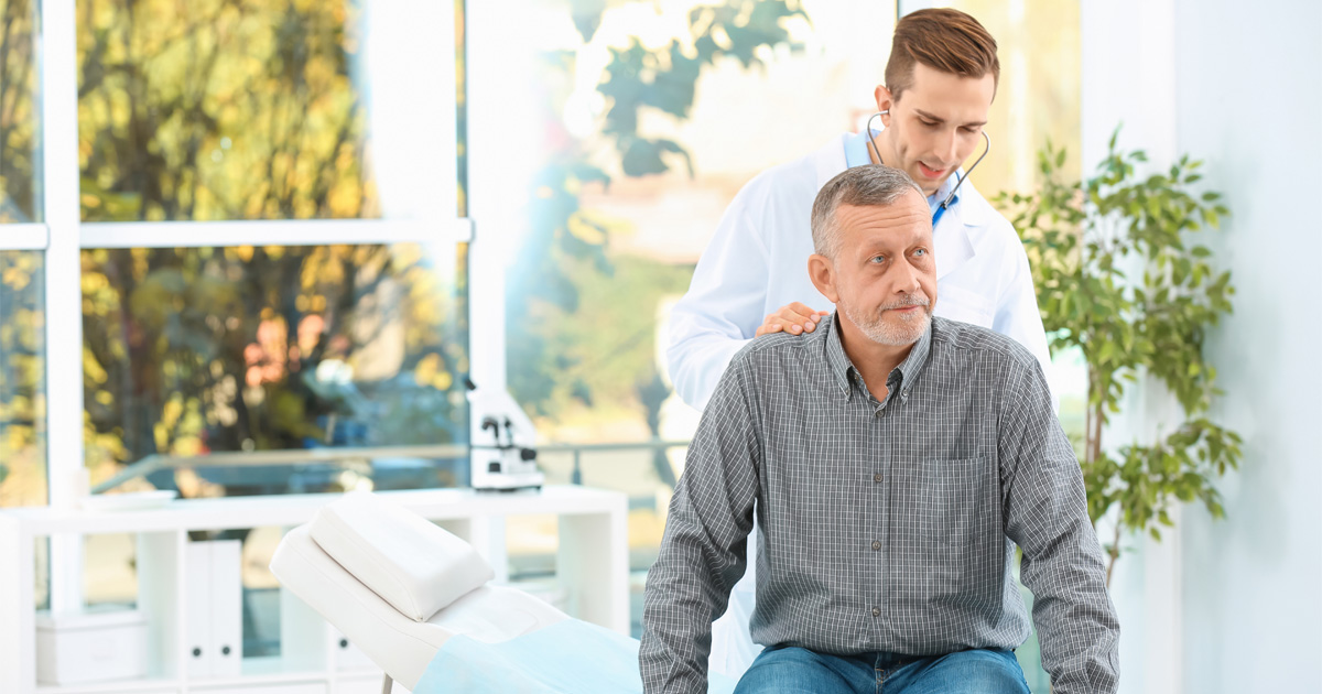 doctor evaluating patient for testosterone replacement therapy for men during hormone consultation